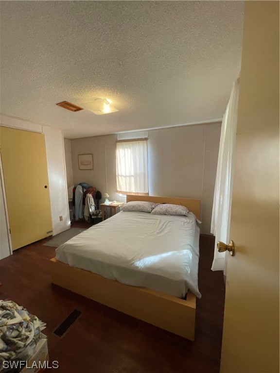 5320 8th Street Clewiston, FL 33440 - Photo 7 of 18 a bedroom with a bed and a lamp on dresser