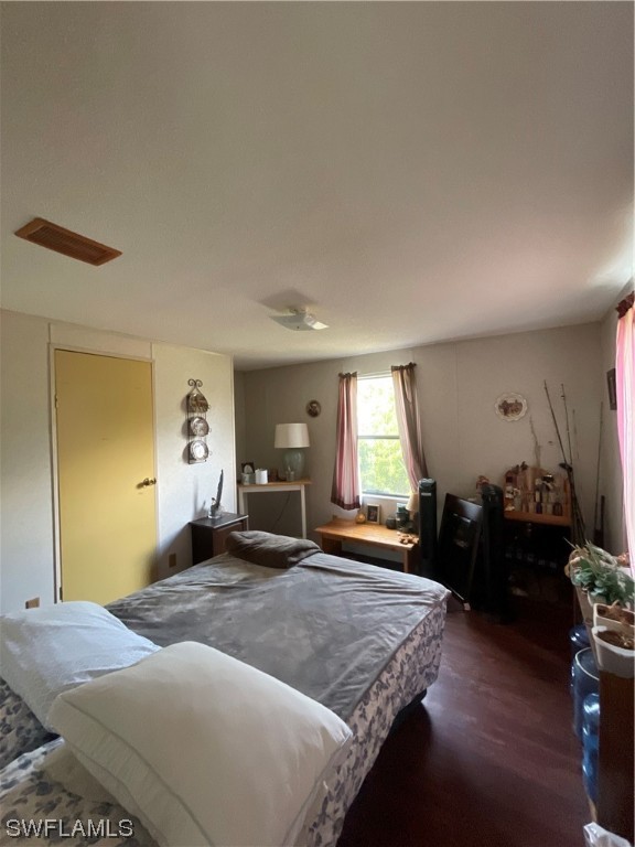 5320 8th Street Clewiston, FL 33440 - Photo 9 of 18 a bedroom with a bed and dresser with mirror