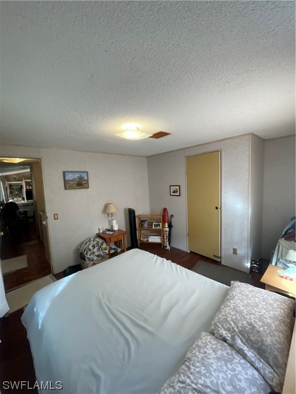 5320 8th Street Clewiston, FL 33440 - Photo 10 of 18 a bedroom with a bed and a chandelier