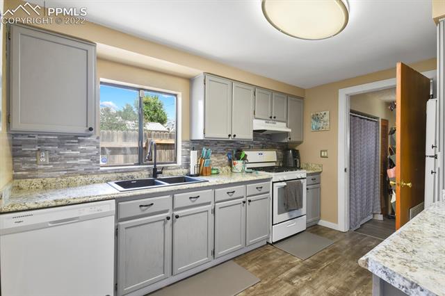 611 Alexander Road Colorado Springs, CO 80909 - Photo 10 of 24 Adorable kitchen with lots of cabinets for all the kitchen musts