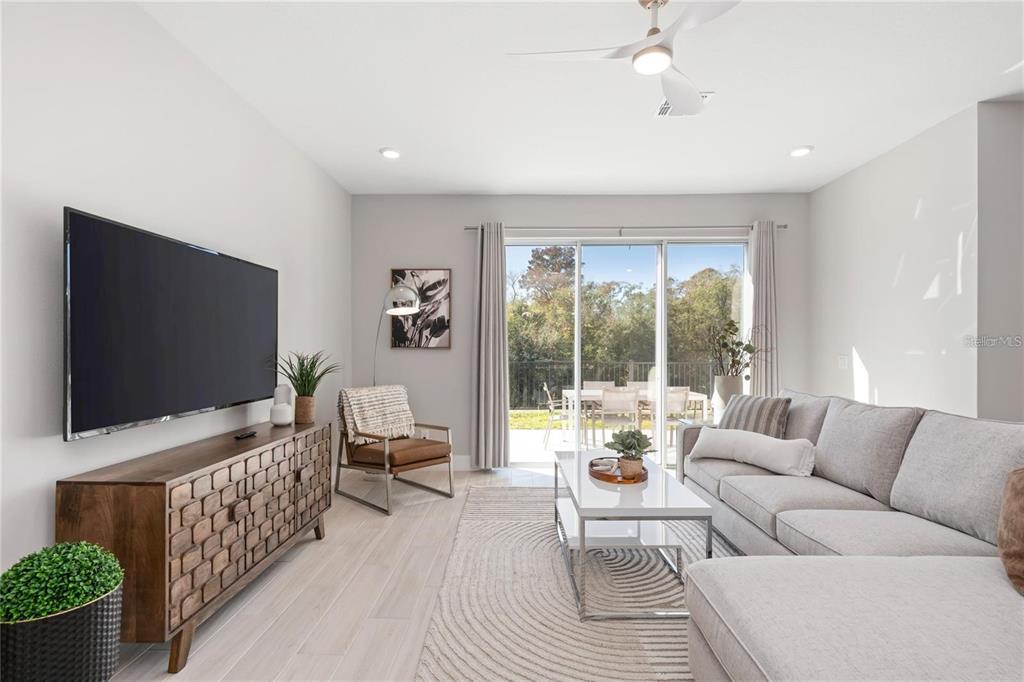7834 Spectrum Drive Reunion, FL 34747 - Photo 6 of 16 a living room with furniture and a flat screen tv