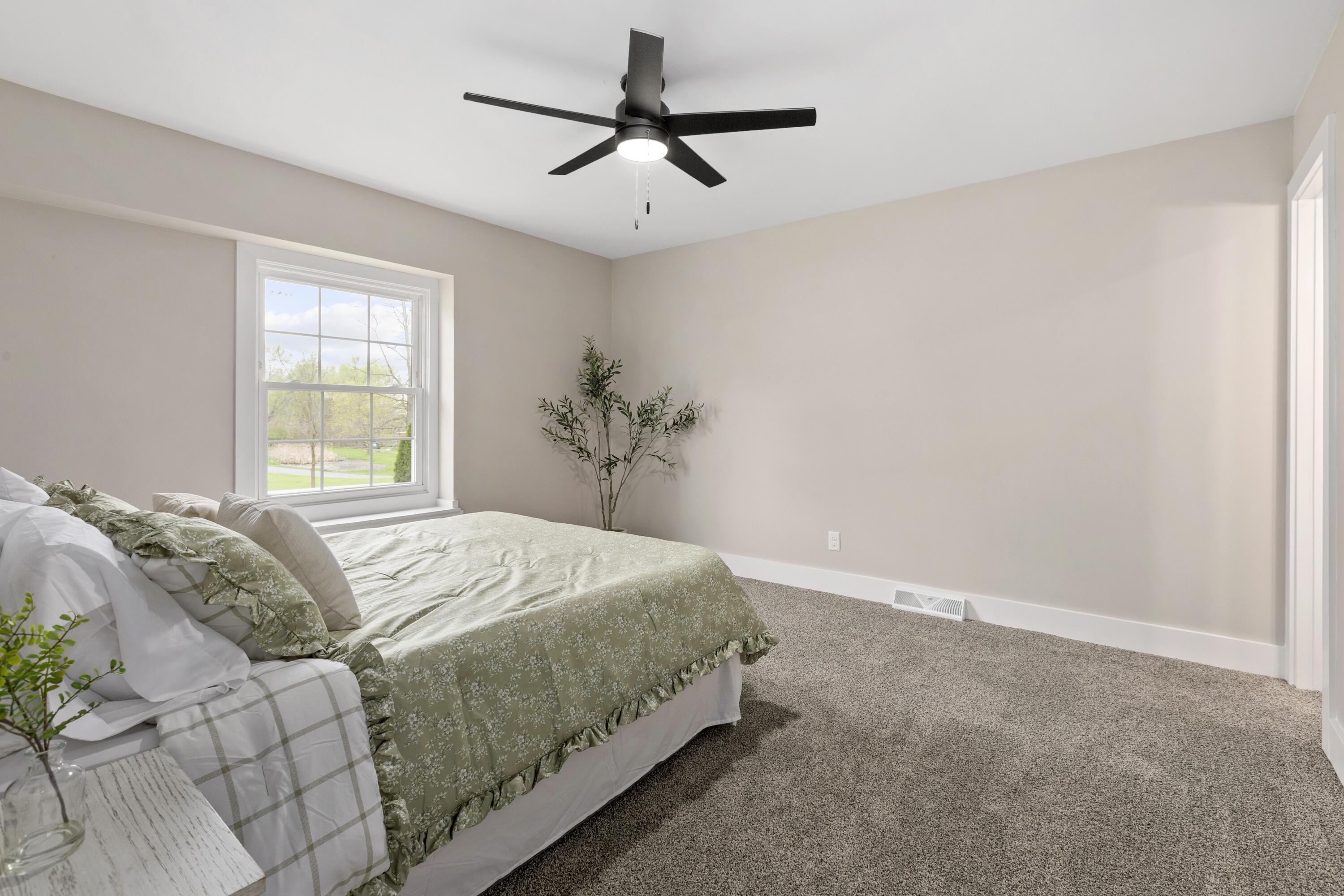 263 West 550 North Valparaiso, IN 46385 - Photo 13 of 23 a bedroom with a bed and a chandelier