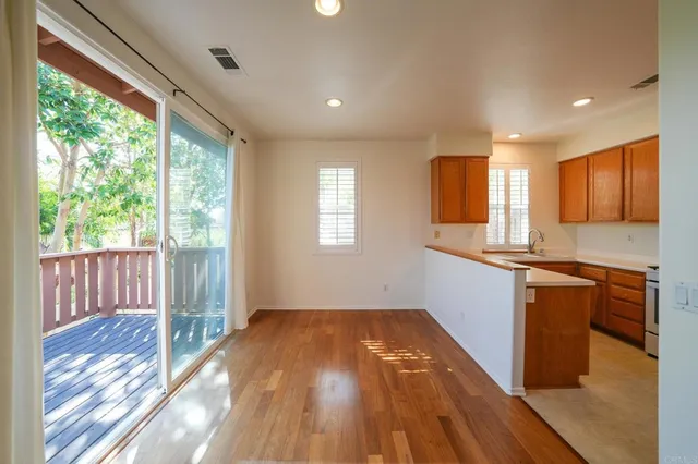 a view of kitchen with wooden floor and electronic appliances