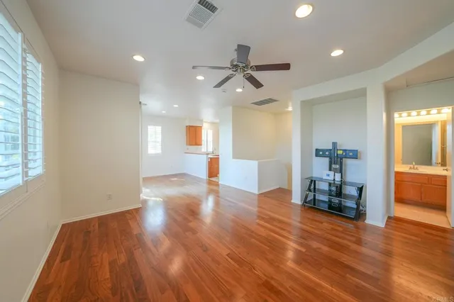 a view of empty room with wooden floor