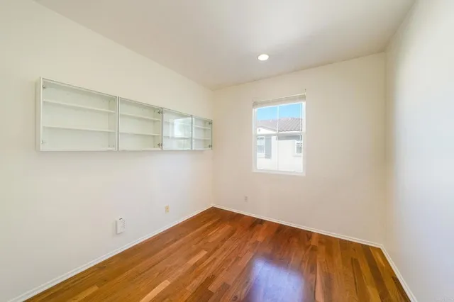 a view of a room with wooden floor and cabinet