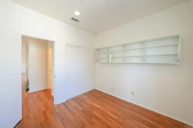 a view of a room with wooden floor and closet