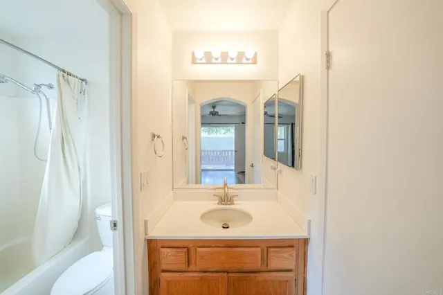 a bathroom with a sink a mirror and a shower