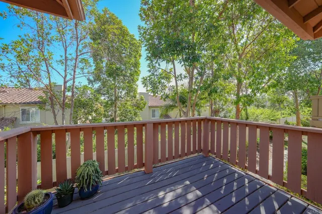 a balcony with wooden floor and outdoor space