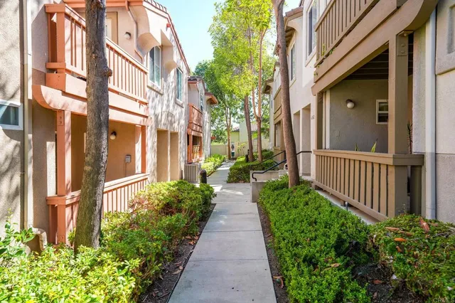 a view of a pathway both side of house