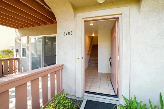 a view of a porch with wooden floor and a potted plant