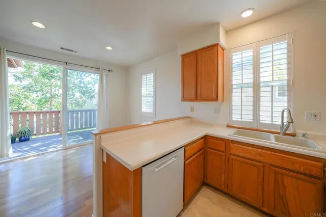 a kitchen with a sink and wooden cabinets