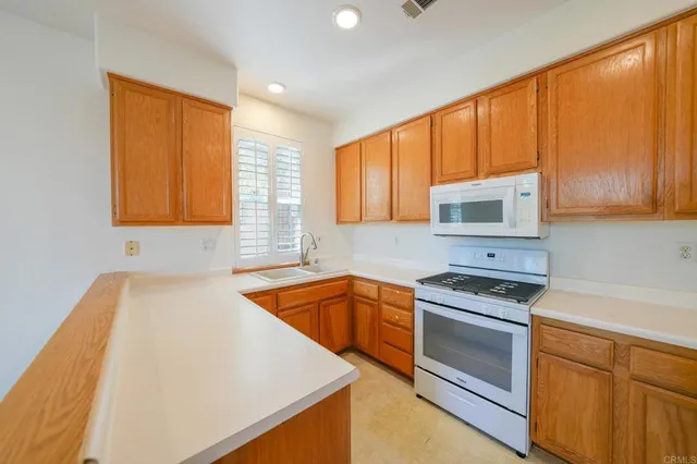 a kitchen that has a sink and a stove top oven