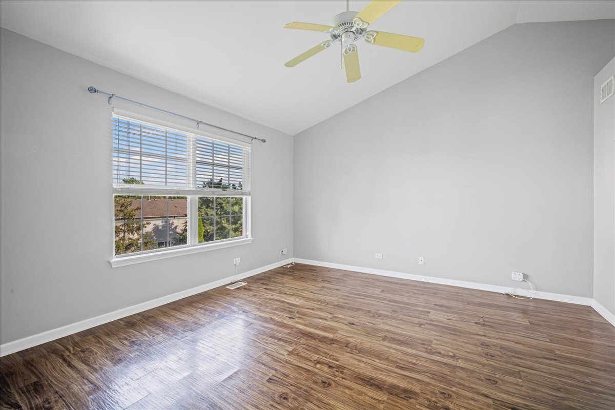 345 Kestrel Lane Lindenhurst, IL 60046 - Photo 12 of 24 wooden floor in an empty room with a window