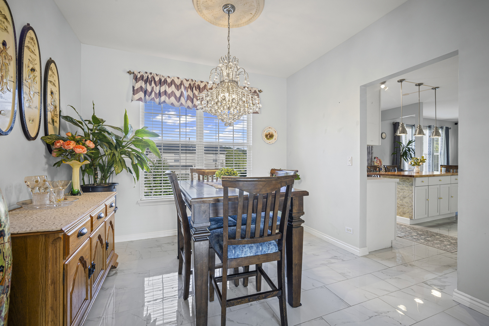 345 Kestrel Lane Lindenhurst, IL 60046 - Photo 4 of 24 a view of a dining room with furniture and chandelier