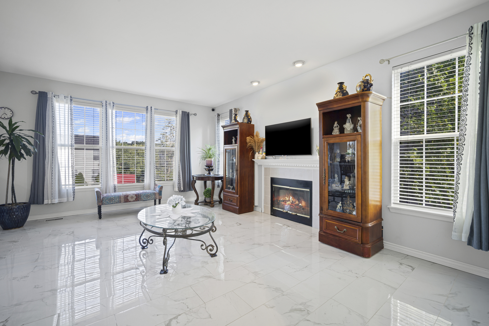 345 Kestrel Lane Lindenhurst, IL 60046 - Photo 9 of 24 a living room with furniture a flat screen tv and a large window