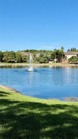 a view of a lake with houses in the back