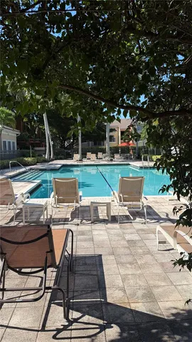 a swimming pool with outdoor seating and yard