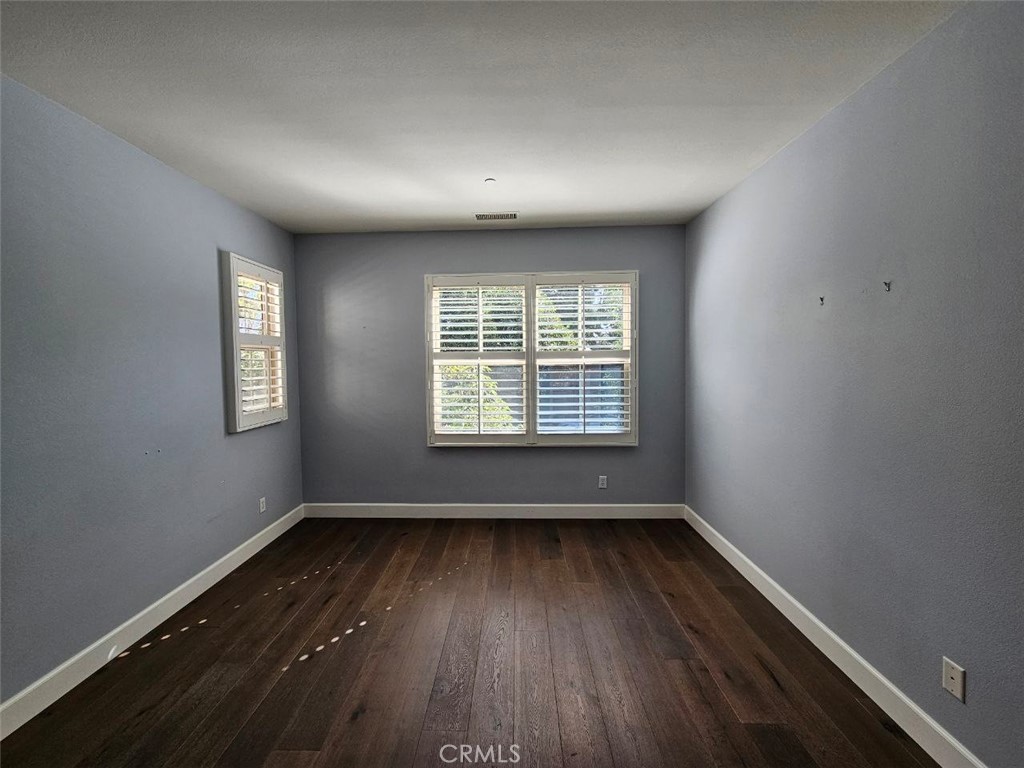 35 Courant Irvine, CA 92618 - Photo 16 of 37 an empty room with wooden floor and windows