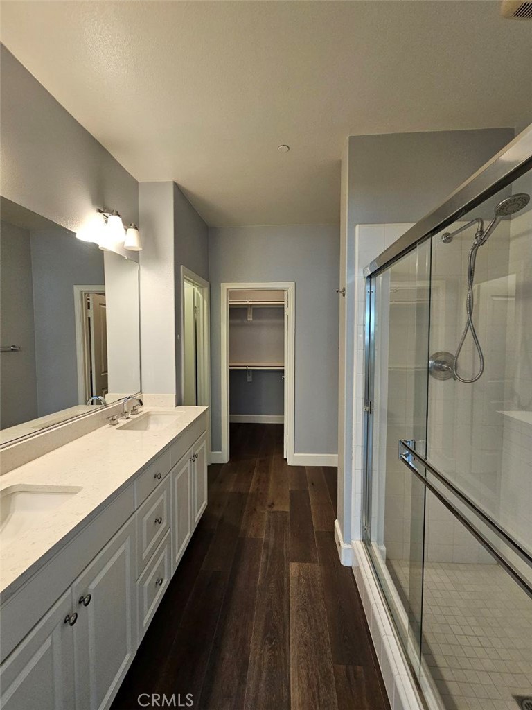 35 Courant Irvine, CA 92618 - Photo 19 of 37 a bathroom with a double vanity sink and mirror with shower