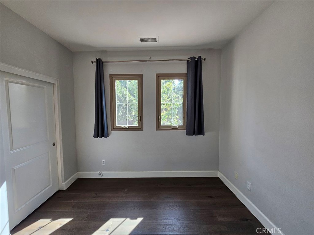 35 Courant Irvine, CA 92618 - Photo 27 of 37 an empty room with wooden floor and windows