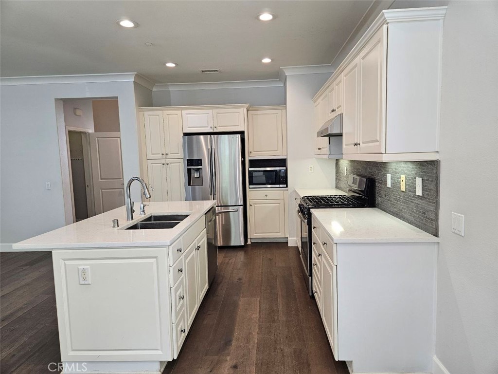 35 Courant Irvine, CA 92618 - Photo 8 of 37 a kitchen that has a sink and a stove in it