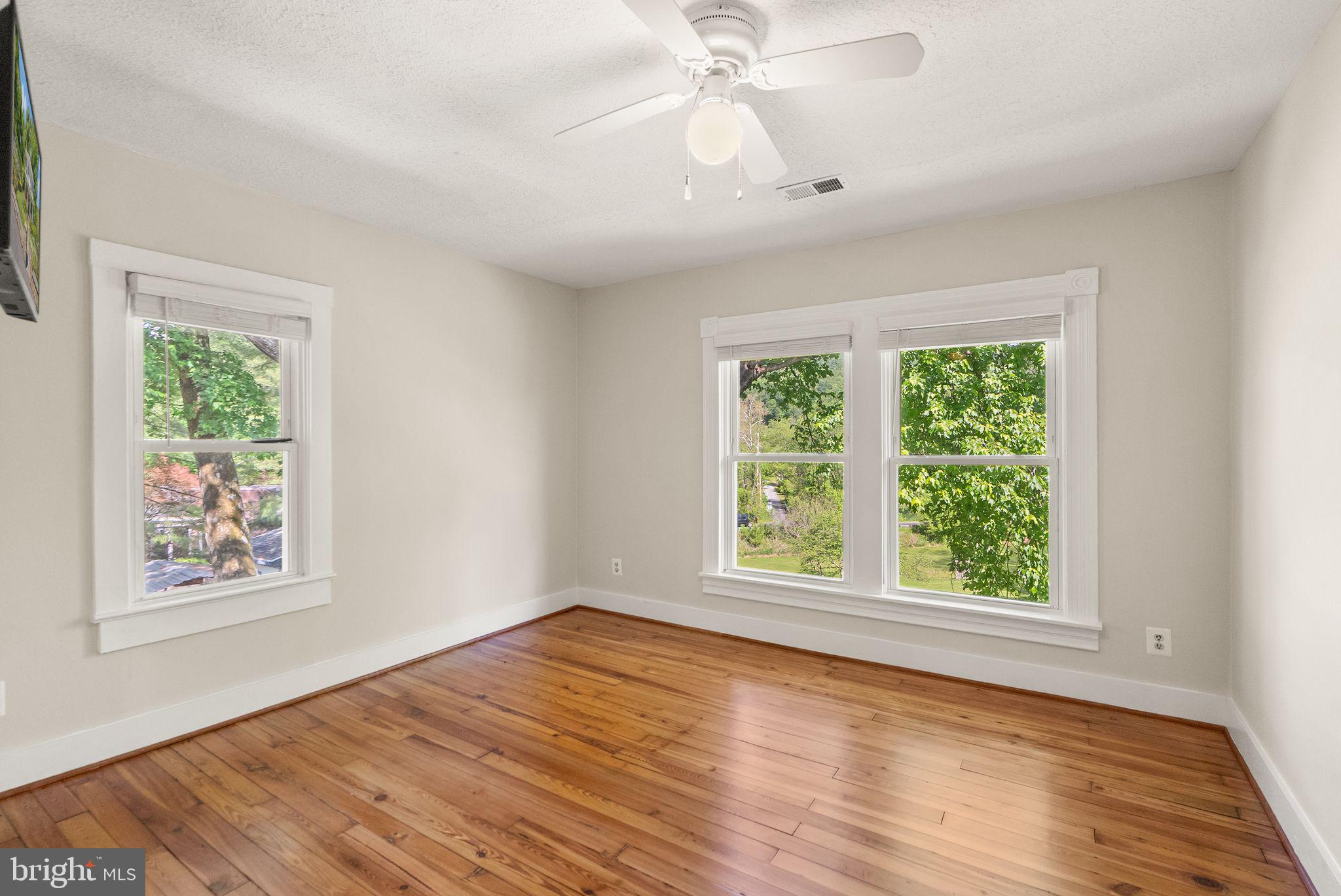 37151 Branchriver Road Purcellville, VA 20132 - Photo 36 of 63 a view of an empty room with wooden floor and a window