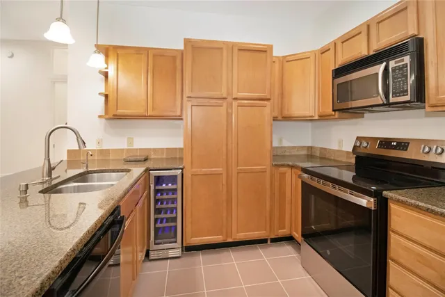 a kitchen with a sink appliances and cabinets