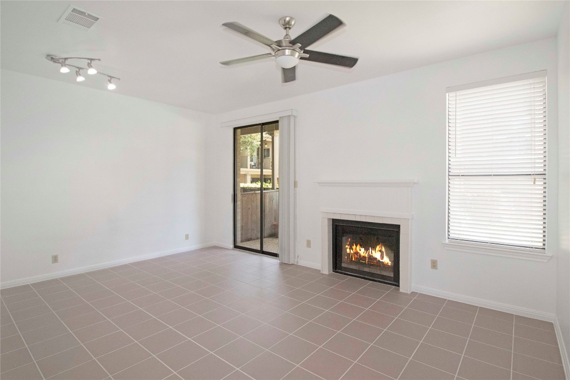 611 East 45th Street, Unit 8 Austin, TX 78751 - Photo 5 of 35 a view of an empty room with a fireplace and a window