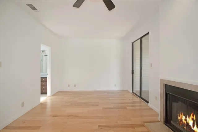 a view of an empty room with closet and a window