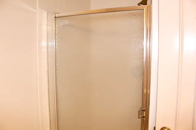 a bathroom with a glass shower door