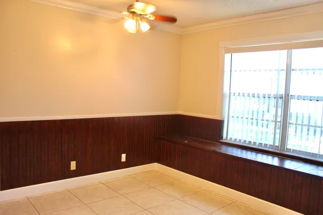 a bedroom with a bed and a potted plant
