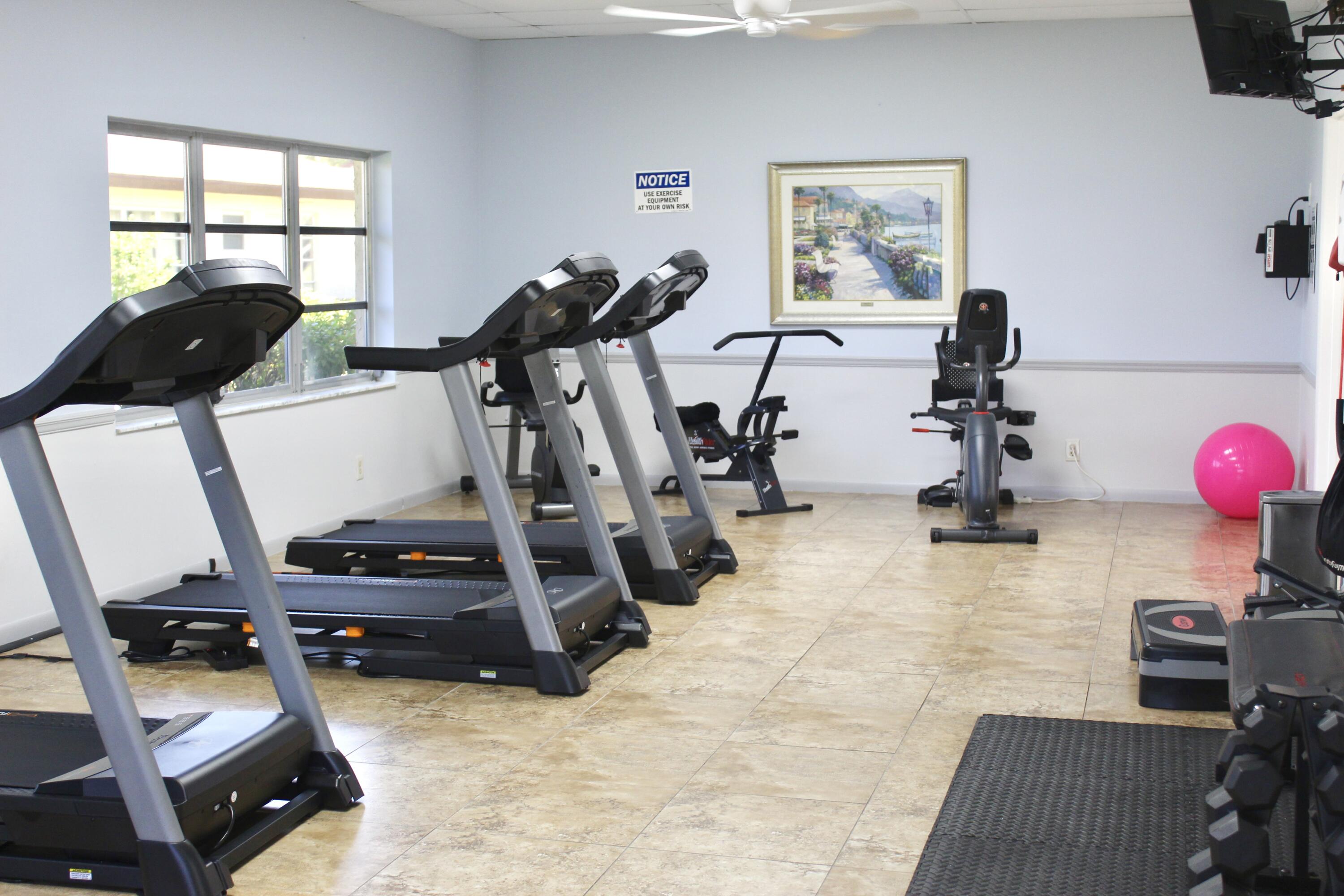 5130 Nesting Way, Unit C Delray Beach, FL 33484 - Photo 30 of 33 a view of a room with gym equipment