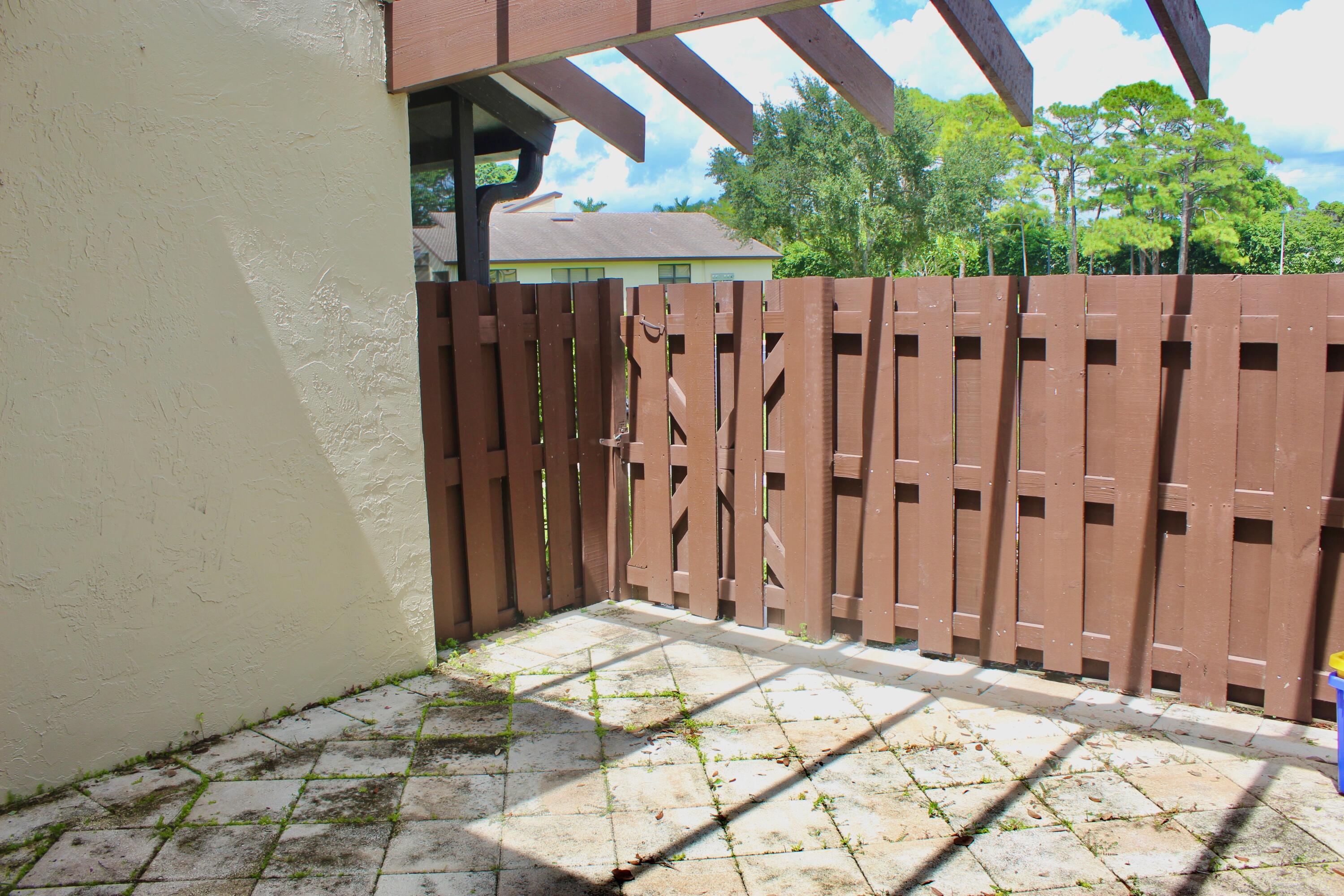 5130 Nesting Way, Unit C Delray Beach, FL 33484 - Photo 5 of 33 a view of a wooden fence