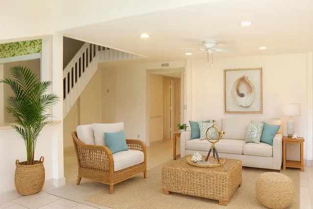 a living room with furniture and a potted plant