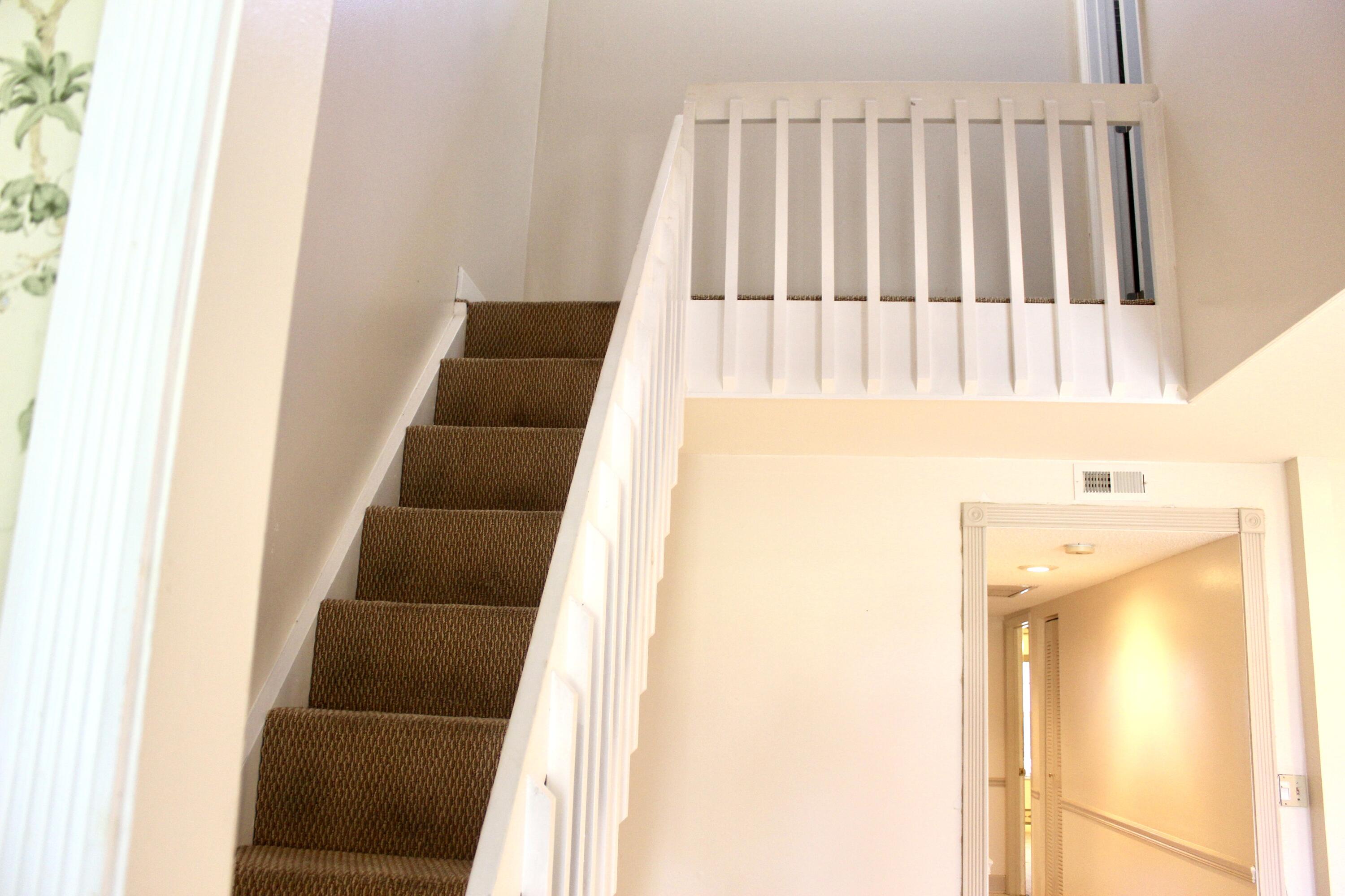 5130 Nesting Way, Unit C Delray Beach, FL 33484 - Photo 10 of 33 a view of staircase with railing and white walls