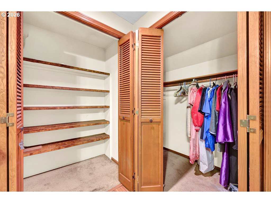 1253 City View Street Eugene, OR 97402 - Photo 11 of 18 a view of walk in closet with clothes and shoes