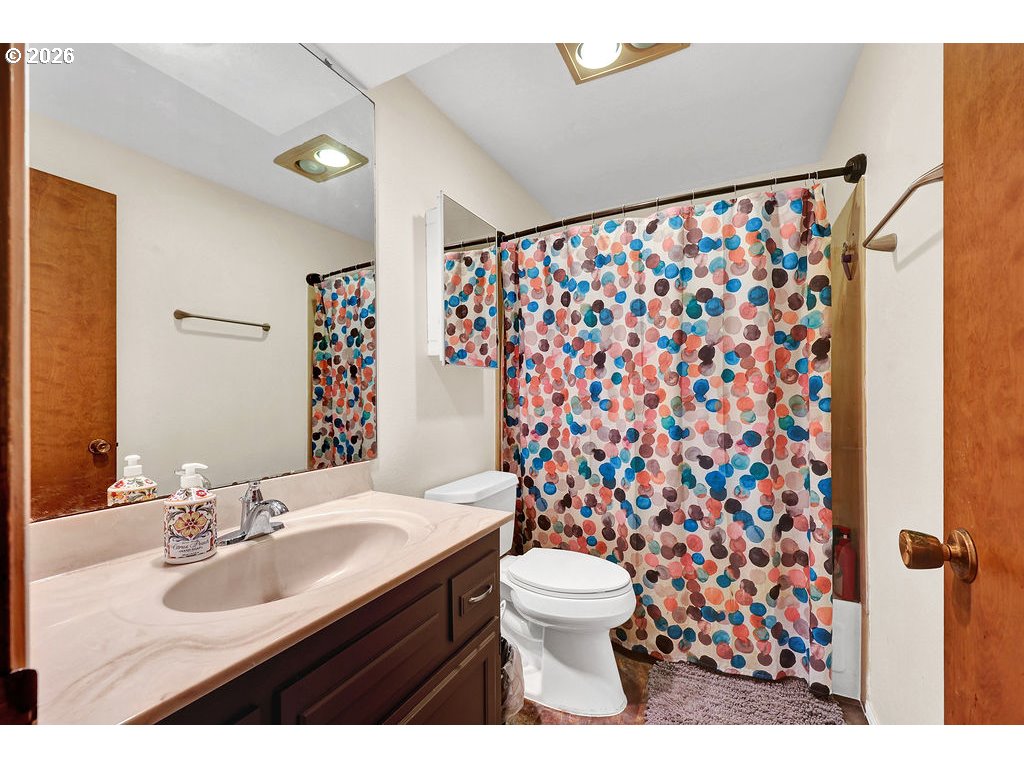 1253 City View Street Eugene, OR 97402 - Photo 12 of 18 a bathroom with a sink toilet and shower