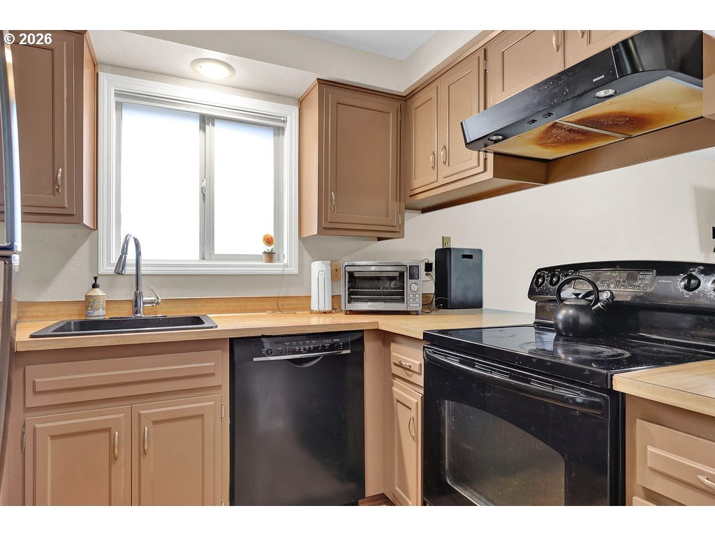 1253 City View Street Eugene, OR 97402 - Photo 5 of 18 a kitchen with stainless steel appliances granite countertop a sink a stove and cabinets