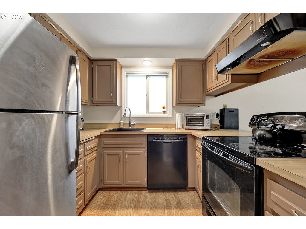 1253 City View Street Eugene, OR 97402 - Photo 6 of 18 a kitchen with cabinets and stainless steel appliances