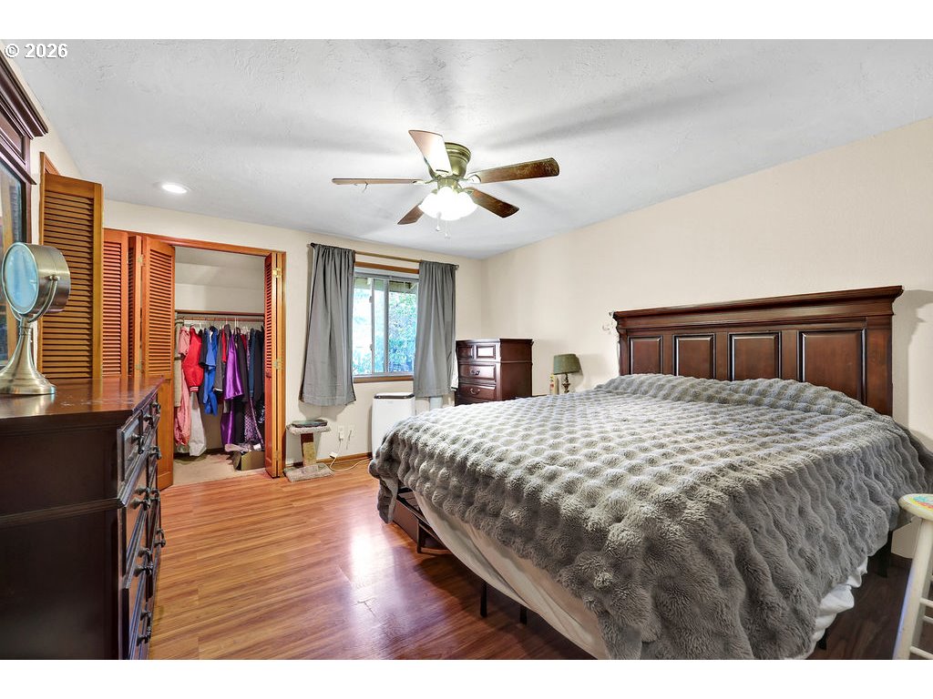 1253 City View Street Eugene, OR 97402 - Photo 10 of 18 a bedroom with a large bed and a chandelier