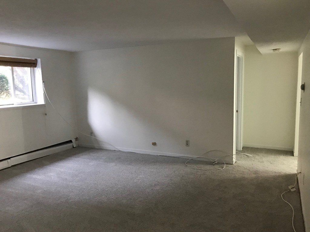 36 Bryon Road, Unit 1 Boston, MA 02467 - Photo 7 of 10 an empty room with windows
