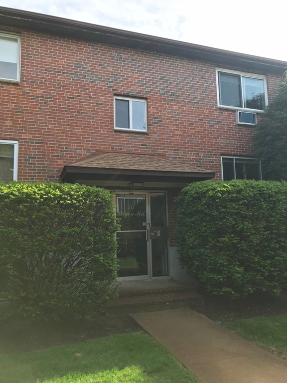 36 Bryon Road, Unit 1 Boston, MA 02467 - Photo 8 of 10 a brick house with a yard
