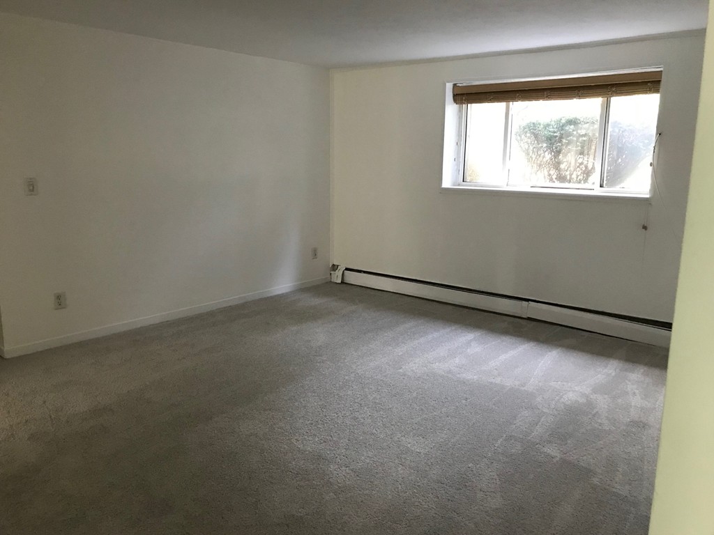 36 Bryon Road, Unit 1 Boston, MA 02467 - Photo 9 of 10 an empty room with windows