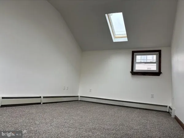 a view of a room with wooden floor and a window