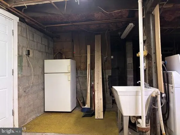 a view of a refrigerator and a table in a room