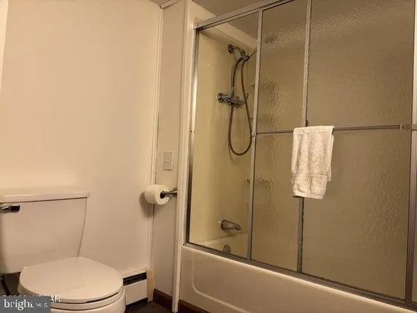 a bathroom with a toilet and shower