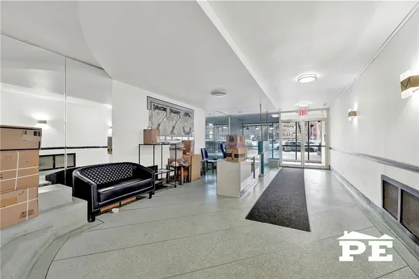 a living room with furniture and a book shelf