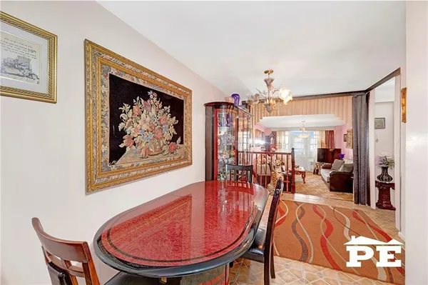 a view of a dining room with furniture and a chandelier