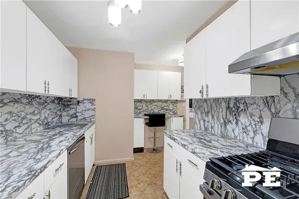 a kitchen with a stove and cabinets
