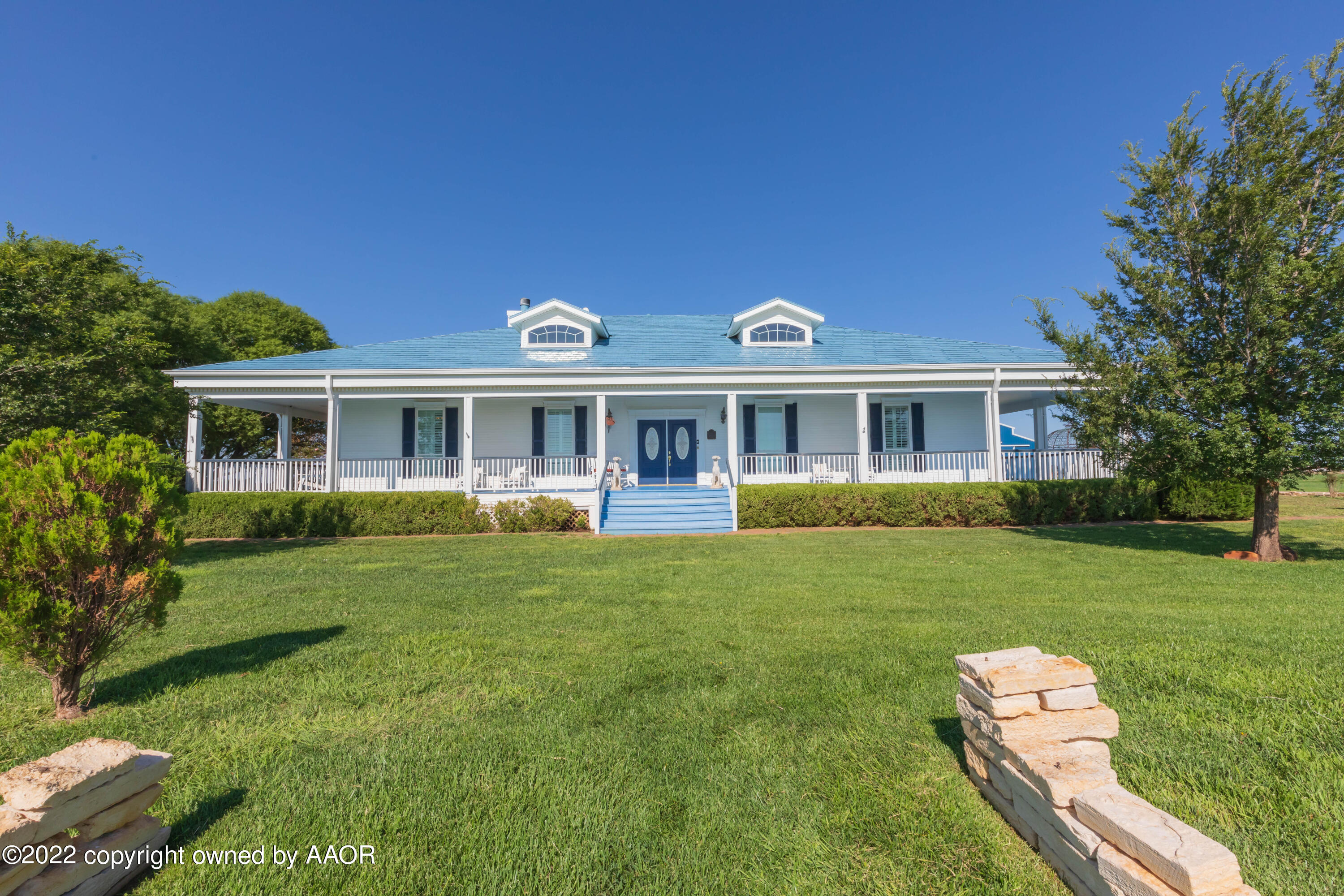 a front view of a house with a yard table and chairs